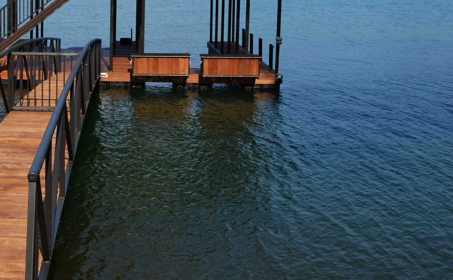 Ipe-decked dock with built-in dock boxes, railed upper deck, and bridge gangway